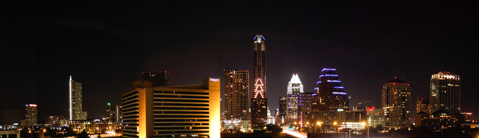 The downtown Austin skyline reflected in Lady Bird Lake at night
